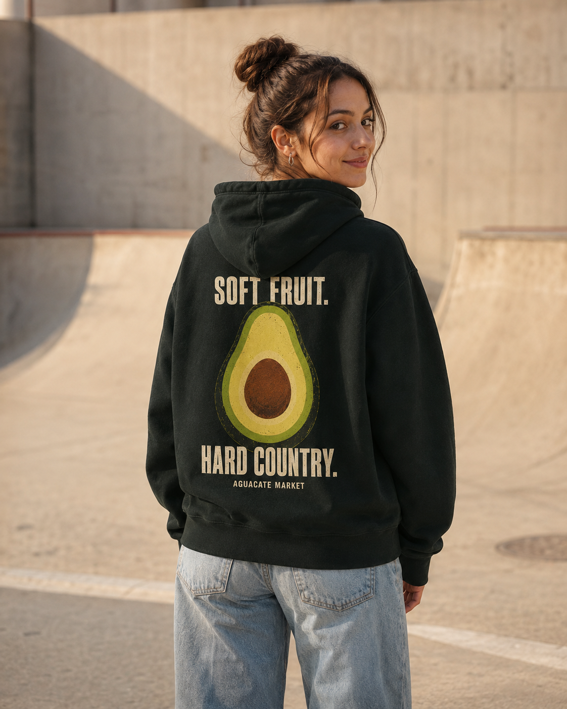 Dark green hoodie worn at a skatepark, back view, SOFT FRUIT. HARD COUNTRY. print visible.