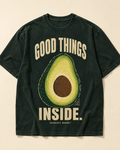 Peel green heavyweight tee, front. GOOD THINGS INSIDE. arched around a cut avocado on the chest.