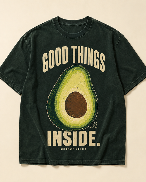 Peel green heavyweight tee, front. GOOD THINGS INSIDE. arched around a cut avocado on the chest.